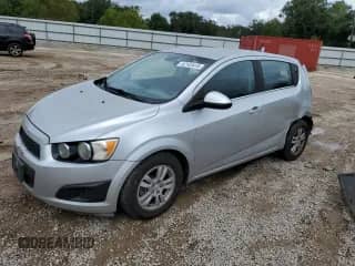 2013 Chevrolet Sonic LT with VIN 1G1JC6SB7D4139806, listed as a Copart auction lot 82143415 with 102,960 mi miles and Salvage title. Bid and sale history available at DreamBid. Image 1.