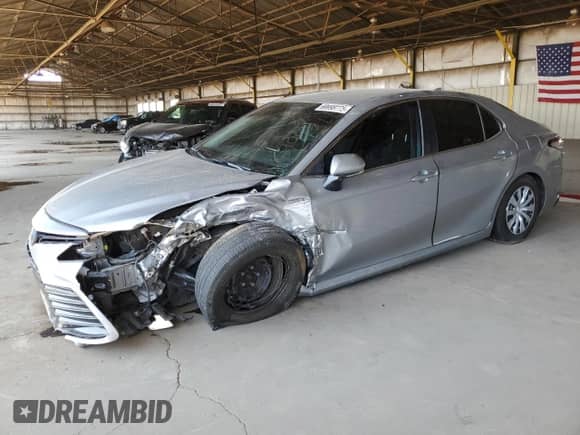 2021 Toyota Camry Hybrid LE with VIN 4T1C31AK5MU554381, listed as a Copart auction lot 69998775 with 104,313 mi miles and Salvage title. Bid and sale history available at DreamBid. Image 1.