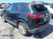 ✅ 2014 Mazda CX-5 Grand Touring • VIN: JM3KE2DY3E0339601 • Lot: 42652114. Wystawiony na IAAI z przebiegiem 153 063 mil. Bezpłatny archiwum sprzedaży aukcyjnych z USA i szczegółowy raport historii pojazdu na DreamBid. Zdjęcie 3.