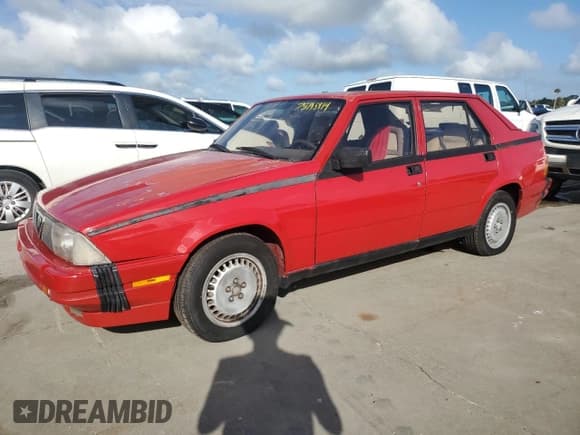 ✅ 1987 Alfa Romeo Milano • VIN: ZARDA1160H1051386 • Лот: 75195914. Опубликован ранее на Copart с пробегом 88 230 миль. Бесплатный доступ к архиву аукционных продаж из США и подробный отчёт об истории автомобиля на DreamBid. Изображение 1.
