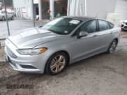 ✅ 2018 Ford Fusion SE • VIN: 3FA6P0H70JR179414 • Лот: 43877600. Опубликован ранее на IAAI с пробегом 153 151 миль. Бесплатный доступ к архиву аукционных продаж из США и подробный отчёт об истории автомобиля на DreamBid. Изображение 2.