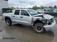 2005 Dodge Dakota Laramie with VIN 1D7HW58N95S200293, listed as a Copart auction lot 56053075 with 104,769 mi miles and Salvage title. Bid and sale history available at DreamBid. Image 4.