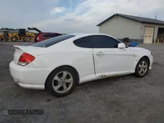 ✅ 2005 Hyundai Tiburon GS • VIN: KMHHM65D35U184724 • Лот: 84444495. Опубликован ранее на Copart с пробегом 203 238 миль. Бесплатный доступ к архиву аукционных продаж из США и подробный отчёт об истории автомобиля на DreamBid. Изображение 3.