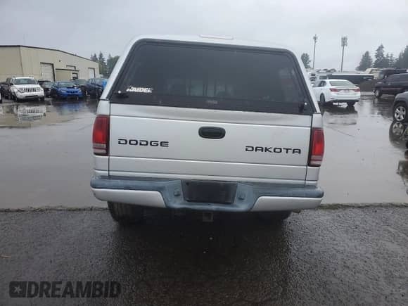 2003 Dodge Dakota Sport z VIN 1D7HG38N83S265442, wystawiony jako Copart lot #84969985 z przebiegiem Nie podano mil oraz Szkoda całkowita • Salvage title. Historia ofert i sprzedaży dostępna na DreamBid. Obrazek 6.