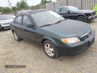 ✅ 2001 Mazda Protege LX • VIN: JM1BJ225910464299 • Lot: 42864156. Wystawiony na IAAI z przebiegiem 117 926 mil. Bezpłatny archiwum sprzedaży aukcyjnych z USA i szczegółowy raport historii pojazdu na DreamBid. Zdjęcie 1.