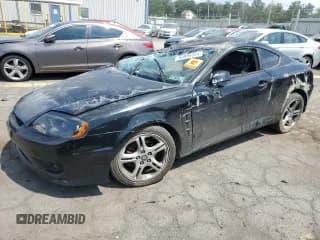 ✅ 2006 Hyundai Tiburon GT • VIN: KMHHN65F76U203646 • Лот: 65899555. Опубликован ранее на Copart с пробегом Не указан. Бесплатный доступ к архиву аукционных продаж из США и подробный отчёт об истории автомобиля на DreamBid. Изображение 1.