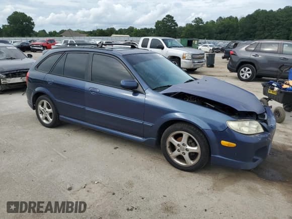 ✅ 2002 Mazda Protege • VIN: JM1BJ245321502702 • Lot: 64486415. Listed on Copart with 355,430 mi. Free auction sales archive from the USA and detailed vehicle history report at DreamBid. Image 4.