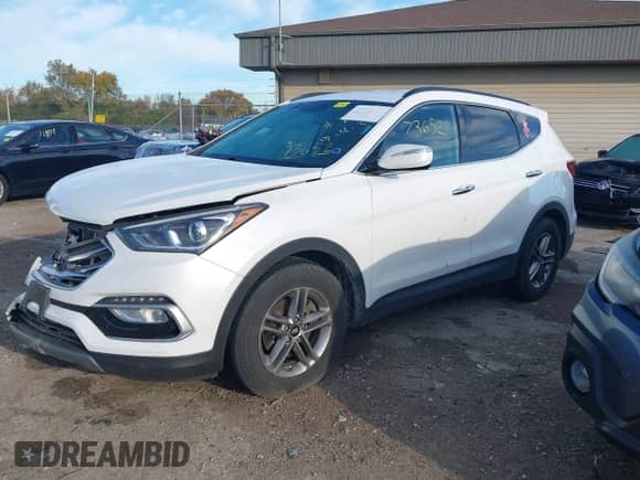 2018 Hyundai Santa Fe 2.4L z VIN 5NMZUDLB1JH097002, wystawiony jako IAAI lot #43473652 z przebiegiem 182 069 mil mil oraz . Historia ofert i sprzedaży dostępna na DreamBid. Obrazek 2.