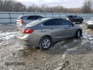 ✅ 2018 Chevrolet Cruze LT • VIN: 1G1BE5SM1J7130586 • Lot: 38795463. Listed on Copart with 99,657 mi. Free auction sales archive from the USA and detailed vehicle history report at DreamBid. Image 3.