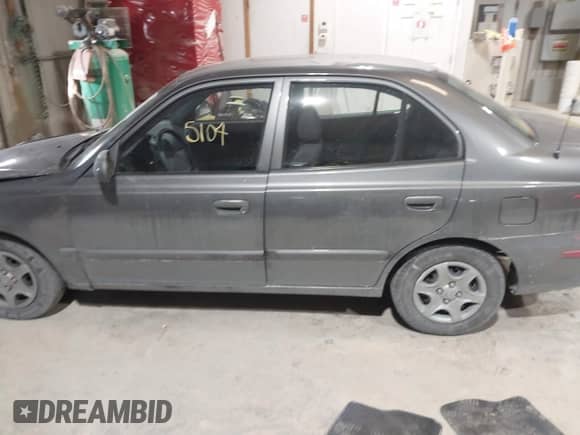 2004 Hyundai Accent GL z VIN KMHCG45C44U528783, wystawiony jako IAAI lot #41535104 z przebiegiem Nie podano mil oraz . Historia ofert i sprzedaży dostępna na DreamBid. Obrazek 14.