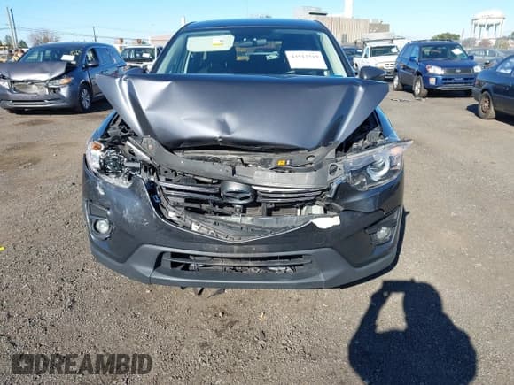 ✅ 2016 Mazda CX-5 Touring • VIN: JM3KE4CY2G0773542 • Lot: 43512519. Listed on IAAI with 64,878 mi. Free auction sales archive from the USA and detailed vehicle history report at DreamBid. Image 6.