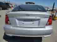 2005 Hyundai Accent GLS with VIN KMHCG35C05U323148, listed as a Copart auction lot 54077465 with 59,182 mi miles and Salvage title. Bid and sale history available at DreamBid. Image 6.