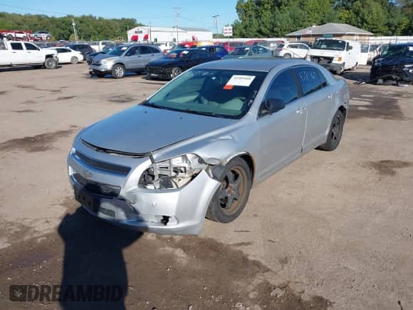 2012 Chevrolet Malibu 1LS with VIN 1G1ZB5E05CF240002, listed as a IAAI auction lot 43385460 with 151,059 mi miles and . Bid and sale history available at DreamBid. Image 2.