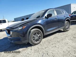 ✅ 2021 Mazda CX-5 Touring • VIN: JM3KFACM2M1354928 • Лот: 90597865. Опубликован ранее на Copart с пробегом 60 018 миль. Бесплатный доступ к архиву аукционных продаж из США и подробный отчёт об истории автомобиля на DreamBid. Изображение 1.