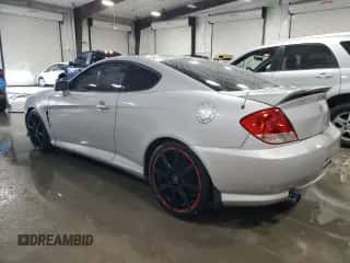 2006 Hyundai Tiburon GT z VIN KMHHN65F96U203924, wystawiony jako Copart lot #43624185 z przebiegiem 120 403 mil mil oraz Szkoda całkowita • Salvage title. Historia ofert i sprzedaży dostępna na DreamBid. Obrazek 2.