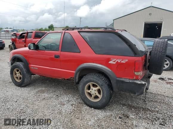 1999 Chevrolet Blazer LS z VIN 1GNCT18W3XK150385, wystawiony jako Copart lot #58490985 z przebiegiem 262 007 mil mil oraz Szkoda całkowita • Salvage title. Historia ofert i sprzedaży dostępna na DreamBid. Obrazek 2.