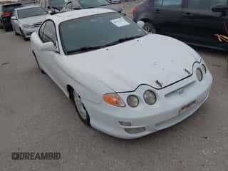 2000 Hyundai Tiburon z VIN KMHJG35F6YU167638, wystawiony jako IAAI lot #42335613 z przebiegiem 254 361 mil mil oraz . Historia ofert i sprzedaży dostępna na DreamBid. Obrazek 1.