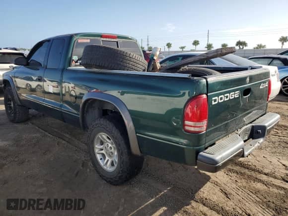 2002 Dodge Dakota z VIN 1B7GG12X52S705975, wystawiony jako Copart lot #75224734 z przebiegiem 150 441 mil mil oraz Szkoda całkowita • Salvage title. Historia ofert i sprzedaży dostępna na DreamBid. Obrazek 2.