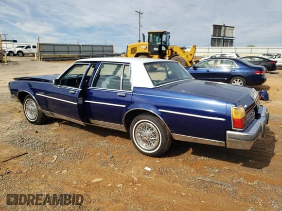 ✅ 1985 Oldsmobile Delta • VIN: 1G3BY69Y2FY379333 • Лот: 68540105. Опубликован ранее на Copart с пробегом 76 044 миль. Бесплатный доступ к архиву аукционных продаж из США и подробный отчёт об истории автомобиля на DreamBid. Изображение 2.