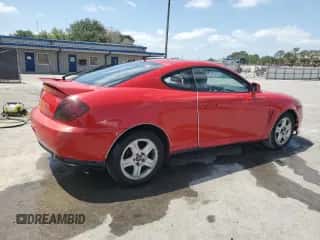 2003 Hyundai Tiburon GT z VIN KMHHN65F33U088538, wystawiony jako Copart lot #54320955 z przebiegiem 220 732 mil mil oraz Szkoda całkowita • Salvage title. Historia ofert i sprzedaży dostępna na DreamBid. Obrazek 3.