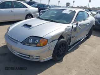 2003 Hyundai Tiburon GT z VIN KMHHN65F93U058914, wystawiony jako IAAI lot #41583584 z przebiegiem 189 671 mil mil oraz . Historia ofert i sprzedaży dostępna na DreamBid. Obrazek 2.