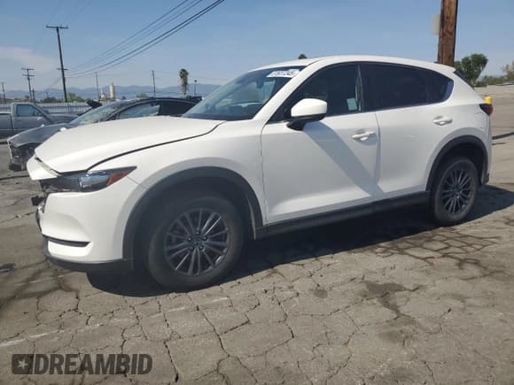 ✅ 2021 Mazda CX-5 Touring • VIN: JM3KFBCM1M1491946 • Лот: 51637245. Опубликован ранее на Copart с пробегом 57 332 миль. Бесплатный доступ к архиву аукционных продаж из США и подробный отчёт об истории автомобиля на DreamBid. Изображение 1.