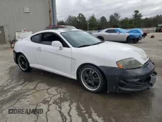 2003 Hyundai Tiburon z VIN KMHHM65D53U042971, wystawiony jako Copart lot #86919434 z przebiegiem 202 250 mil mil oraz Szkoda całkowita • Salvage title. Historia ofert i sprzedaży dostępna na DreamBid. Obrazek 4.
