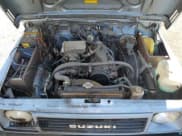 ✅ 1988 Suzuki Samurai • VIN: JS4JC51C2J4256018 • Lot: 81606735. Wystawiony na Copart z przebiegiem 91 755 mil. Bezpłatny archiwum sprzedaży aukcyjnych z USA i szczegółowy raport historii pojazdu na DreamBid. Zdjęcie 11.