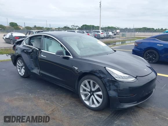 ✅ 2019 Tesla Model 3 Mid Range • VIN: 5YJ3E1EA7KF431980 • Lot: 42242706. Listed on IAAI with 156,456 mi. Free auction sales archive from the USA and detailed vehicle history report at DreamBid. Image 1.
