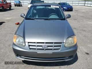 2003 Hyundai Accent GL z VIN KMHCG45C63U476751, wystawiony jako Copart lot #66774675 z przebiegiem 113 600 mil mil oraz Szkoda całkowita • Salvage title. Historia ofert i sprzedaży dostępna na DreamBid. Obrazek 5.