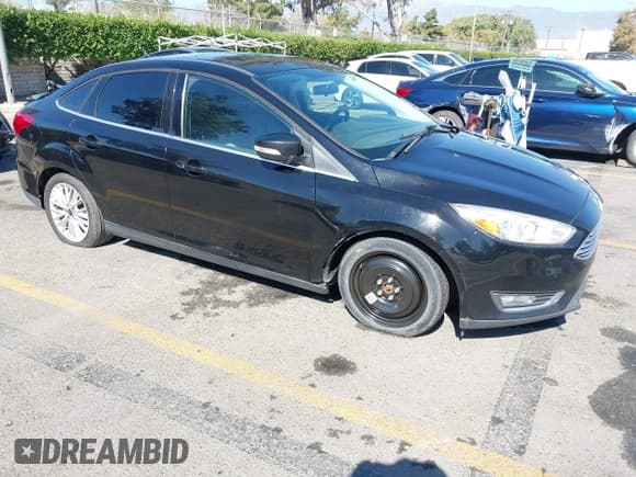 ✅ 2017 Ford Focus Titanium • VIN: 1FADP3J2XHL292836 • Lot: 43530504. Listed on IAAI with 74,713 mi. Free auction sales archive from the USA and detailed vehicle history report at DreamBid. Image 1.