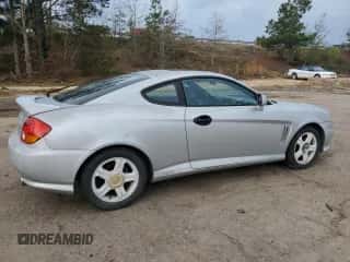 2003 Hyundai Tiburon GT с VIN KMHHN65F13U013420, выставлен на аукционе Copart как лот 51234495 с пробегом 230 612 миль миль и Списание • Salvage title. История ставок и продаж доступна на DreamBid. Изображение 3.