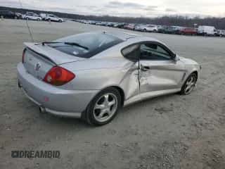 2003 Hyundai Tiburon GT z VIN KMHHN65F63U064962, wystawiony jako Copart lot #44804045 z przebiegiem 186 171 mil mil oraz Szkoda całkowita • Salvage title. Historia ofert i sprzedaży dostępna na DreamBid. Obrazek 3.