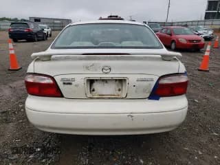 ✅ 2001 Mazda 626 LX • VIN: 1YVGF22C515251837 • Лот: 56854605. Опубликован ранее на Copart с пробегом 173 148 миль. Бесплатный доступ к архиву аукционных продаж из США и подробный отчёт об истории автомобиля на DreamBid. Изображение 6.