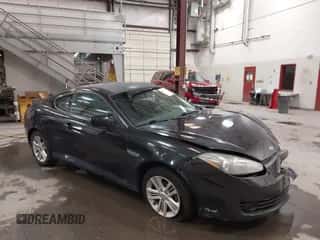 2007 Hyundai Tiburon GS z VIN KMHHM66DX7U255080, wystawiony jako IAAI lot #42128738 z przebiegiem 160 428 mil mil oraz . Historia ofert i sprzedaży dostępna na DreamBid. Obrazek 1.