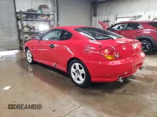 2003 Hyundai Tiburon с VIN KMHHM65D73U018137, выставлен на аукционе Copart как лот 50370215 с пробегом 162 258 миль миль и Списание • Salvage title. История ставок и продаж доступна на DreamBid. Изображение 2.