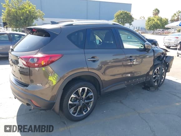 ✅ 2016 Mazda CX-5 Grand Touring • VIN: JM3KE4DY8G0666879 • Lot: 43322818. Listed on IAAI with 104,077 mi. Free auction sales archive from the USA and detailed vehicle history report at DreamBid. Image 4.