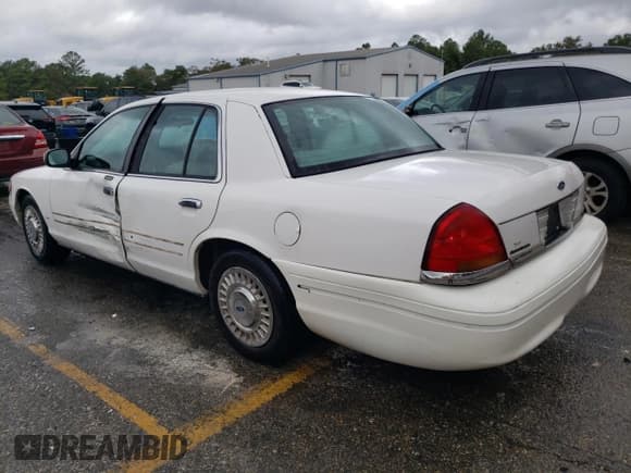 ✅ 1999 Ford Crown Victoria • VIN: 2FAFP73W8XX150079 • Lot: 78923624. Listed on Copart with 128,510 mi. Free auction sales archive from the USA and detailed vehicle history report at DreamBid. Image 2.