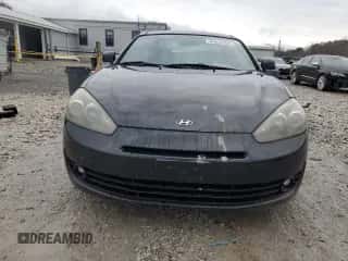 2007 Hyundai Tiburon GS z VIN KMHHM66D17U248440, wystawiony jako Copart lot #86642384 z przebiegiem 125 156 mil mil oraz Czysty tytuł • Clean title. Historia ofert i sprzedaży dostępna na DreamBid. Obrazek 5.