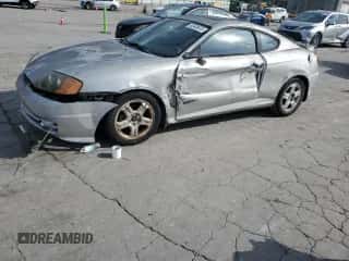 ✅ 2003 Hyundai Tiburon GT • VIN: KMHHN65F03U055237 • Лот: 82400615. Опубликован ранее на Copart с пробегом 244 468 миль. Бесплатный доступ к архиву аукционных продаж из США и подробный отчёт об истории автомобиля на DreamBid. Изображение 1.