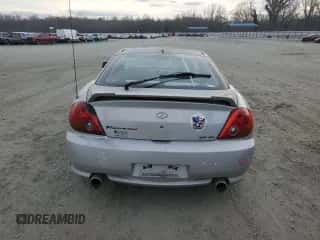 2003 Hyundai Tiburon GT z VIN KMHHN65F63U064962, wystawiony jako Copart lot #44804045 z przebiegiem 186 171 mil mil oraz Szkoda całkowita • Salvage title. Historia ofert i sprzedaży dostępna na DreamBid. Obrazek 6.