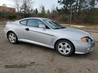 2003 Hyundai Tiburon GT с VIN KMHHN65F13U013420, выставлен на аукционе Copart как лот 51234495 с пробегом 230 612 миль миль и Списание • Salvage title. История ставок и продаж доступна на DreamBid. Изображение 4.