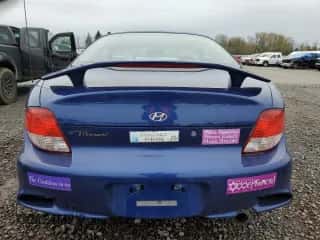 2001 Hyundai Tiburon z VIN KMHJG25F91U250108, wystawiony jako Copart lot #50905795 z przebiegiem 61 803 mil mil oraz Szkoda całkowita • Salvage title. Historia ofert i sprzedaży dostępna na DreamBid. Obrazek 6.