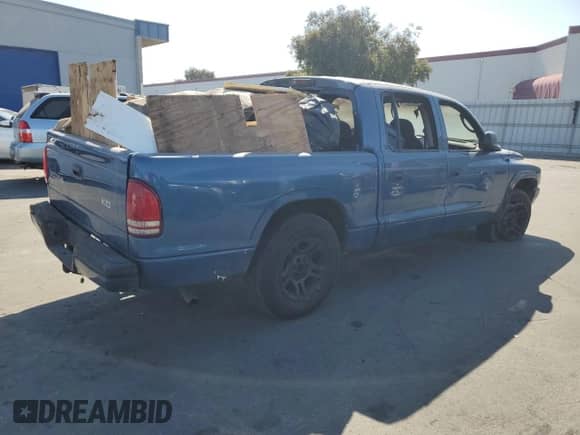 2003 Dodge Dakota Sport z VIN 1D7HL38X33S144315, wystawiony jako Copart lot #65842394 z przebiegiem Nie podano mil oraz Szkoda całkowita • Salvage title. Historia ofert i sprzedaży dostępna na DreamBid. Obrazek 3.