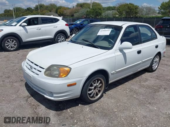 2003 Hyundai Accent GL z VIN KMHCG45C53U468978, wystawiony jako IAAI lot #41999193 z przebiegiem 105 514 mil mil oraz . Historia ofert i sprzedaży dostępna na DreamBid. Obrazek 17.
