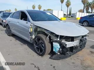 ✅ 2025 Kia K5 GT-Line • VIN: KNAG64J71S5284404 • Лот: 43644605. Опубликован ранее на IAAI с пробегом 21 656 миль. Бесплатный доступ к архиву аукционных продаж из США и подробный отчёт об истории автомобиля на DreamBid. Изображение 1.