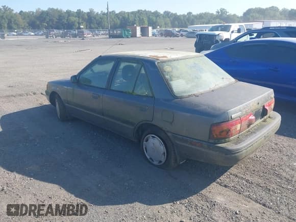 ✅ 1992 Mazda Protege • VIN: JM1BG2262N0508852 • Lot: 43184811. Listed on IAAI with 152,900 mi. Free auction sales archive from the USA and detailed vehicle history report at DreamBid. Image 3.