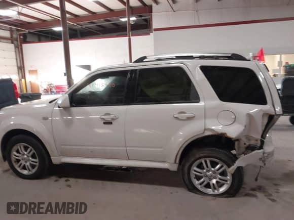 2009 Mercury Mariner Premier with VIN 4M2CU97729KJ00086, listed as a IAAI auction lot 41418490 with 167,486 mi miles and . Bid and sale history available at DreamBid. Image 14.