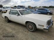 ✅ 1984 Cadillac Eldorado • VIN: 1G6AL5782EE603047 • Lot: 76777394. Listed on Copart with 33,384 mi. Free auction sales archive from the USA and detailed vehicle history report at DreamBid. Image 4.