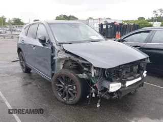 ✅ 2021 Mazda CX-5 Carbon Edition • VIN: JM3KFACYXM0323774 • Lot: 42658043. Listed on IAAI with 53,003 mi. Free auction sales archive from the USA and detailed vehicle history report at DreamBid. Image 1.